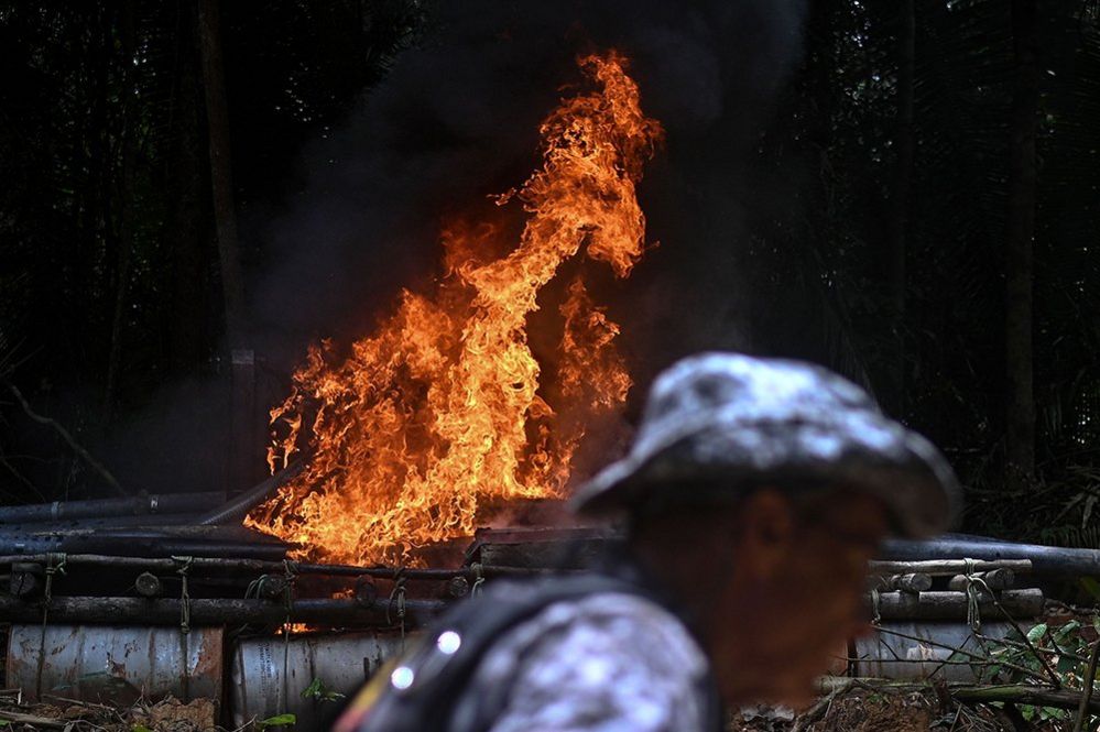 Agents of the National Security Force burn illegal mining equipment during an operation by Brazilian authorities against the advance of deforestation and illegal mining in the Itaituba II Environmental Forest, Brazil, 15 February 2023.