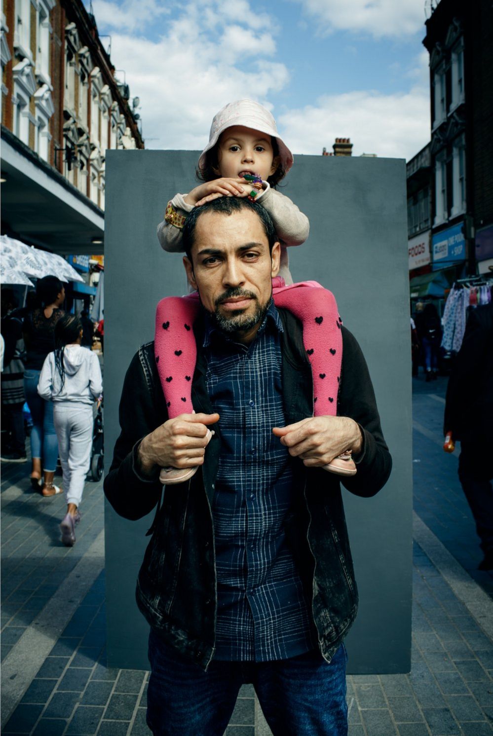 Portrait of a man with a child sat on his shoulders