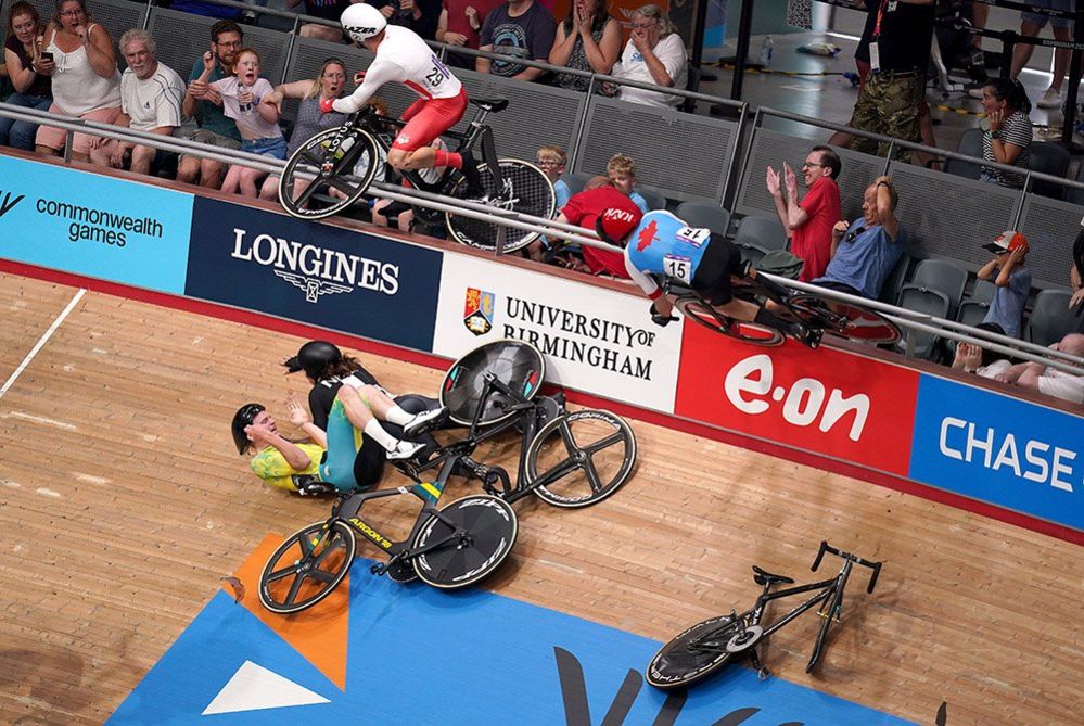 A crash in the Men's 15km Scratch Race Qualifying Round as England's Matt Walls (no.29) goes over the barrier into the crowd and Canada's Derek Gee (no.15) rides the outside wall at Lee Valley VeloPark on day three of the 2022 Commonwealth Games in London, 1 July 2022