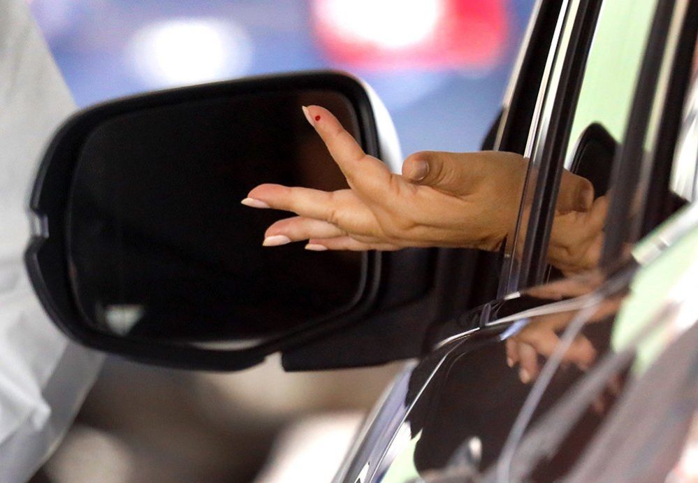 A woman's hand sticks through a car window