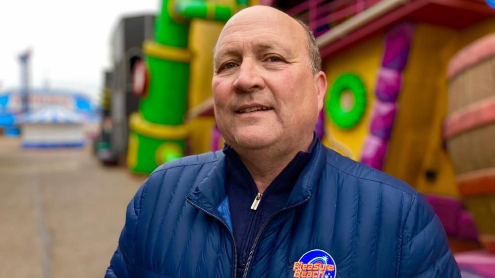 Albert Jones in front of the House of Fun at the Great Yarmouth Pleasure Beach