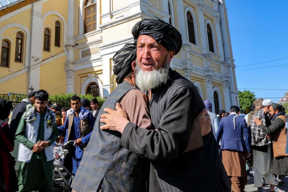 People greet each other after Eid al-Fitr prayers in Kabul, Afghanistan