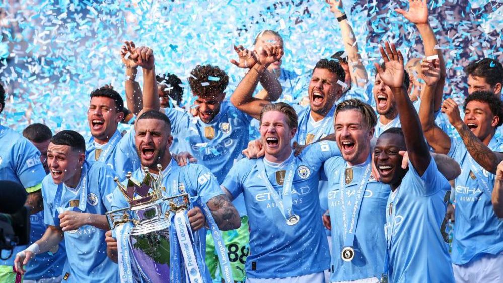 Manchester City players celebrate winning the Premier League