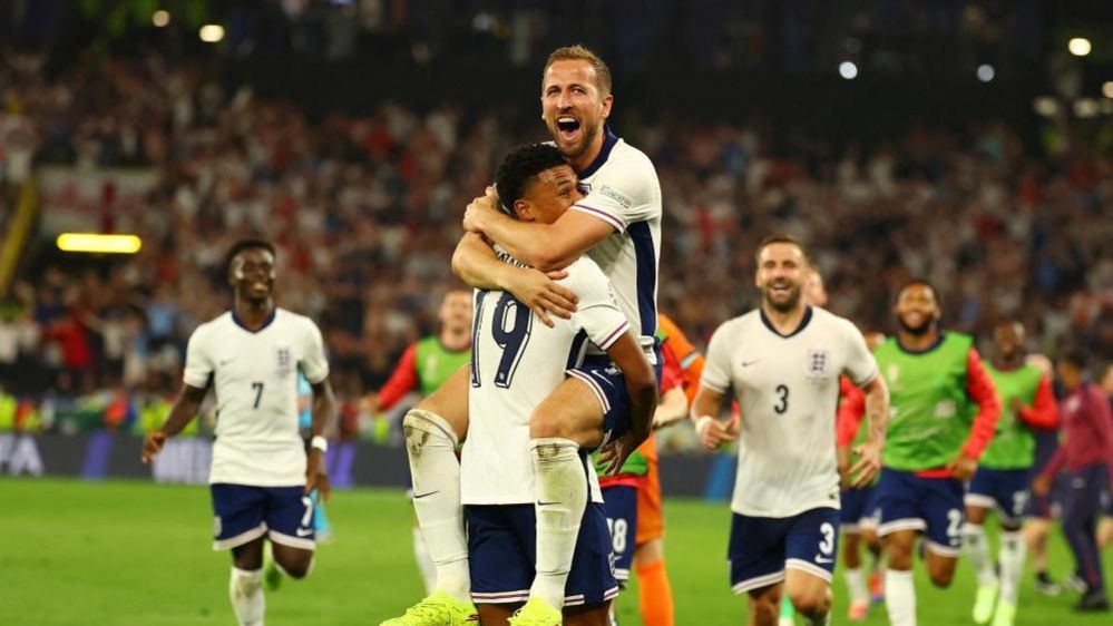 Harry Kane celebrates with Ollie Watkins after winning the match