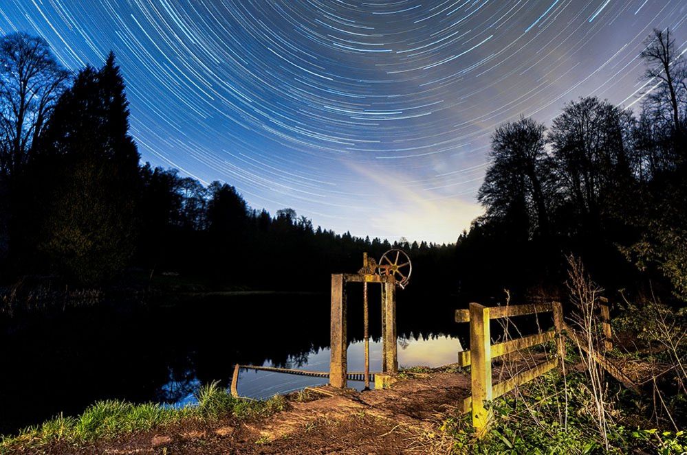 Star trail taken over Miserden Lake on the Miserden Estate, at the village of Miserden near Stroud, Gloucestershire