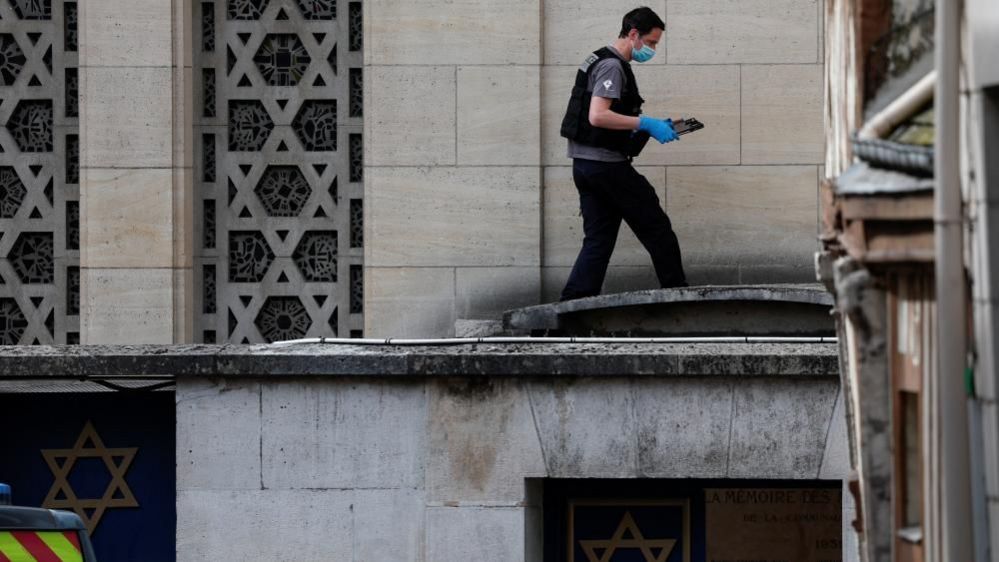 A French police forensics member collects evidence after officers shot dead an armed man earlier who set fire to the city's synagogue in Rouen, France, May 17, 2024