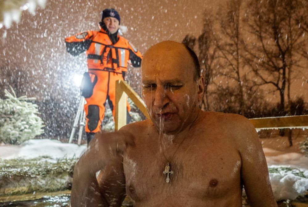 A man takes a dip in the icy water of a pond during Orthodox Epiphany celebrations in Moscow, Russia