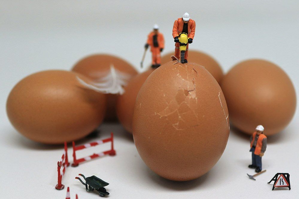 Model of a man cracking an egg