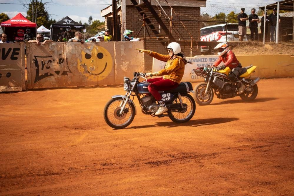 Flat track motorcycle racers in action