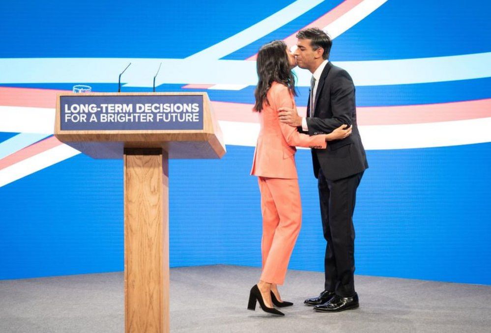 Akshata Murty greets her husband Prime Minister Rishi Sunak on stage