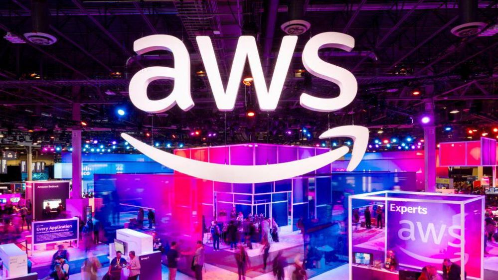 ttendees walk through an expo hall at AWS re:Invent 2023, a conference hosted by Amazon Web Services