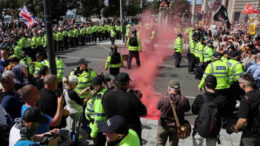 Police officers and demonstrators face-off during a protest against illegal immigration, in Liverpool, Britain, August 3, 2024