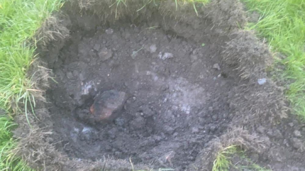 A crater left by a controlled explosion when bomb disposal experts dealt with a grenade in Cradley Heath
