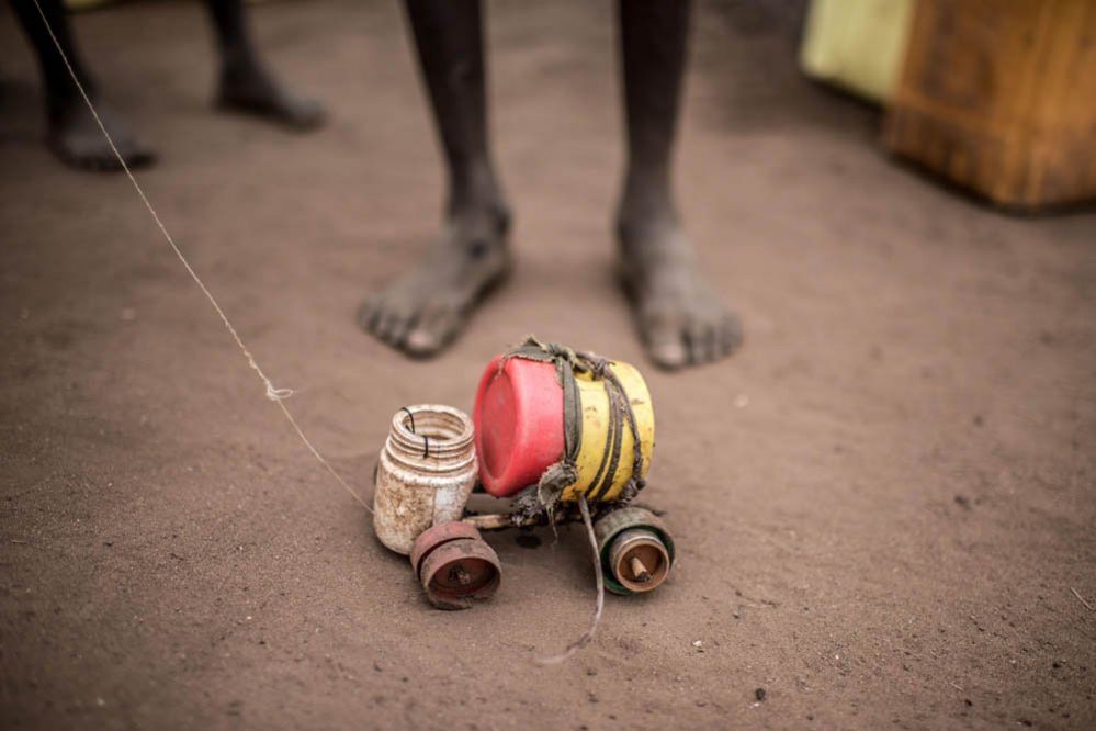 A boy plays with a toy car in Rhino refugee camp in northern Uganda