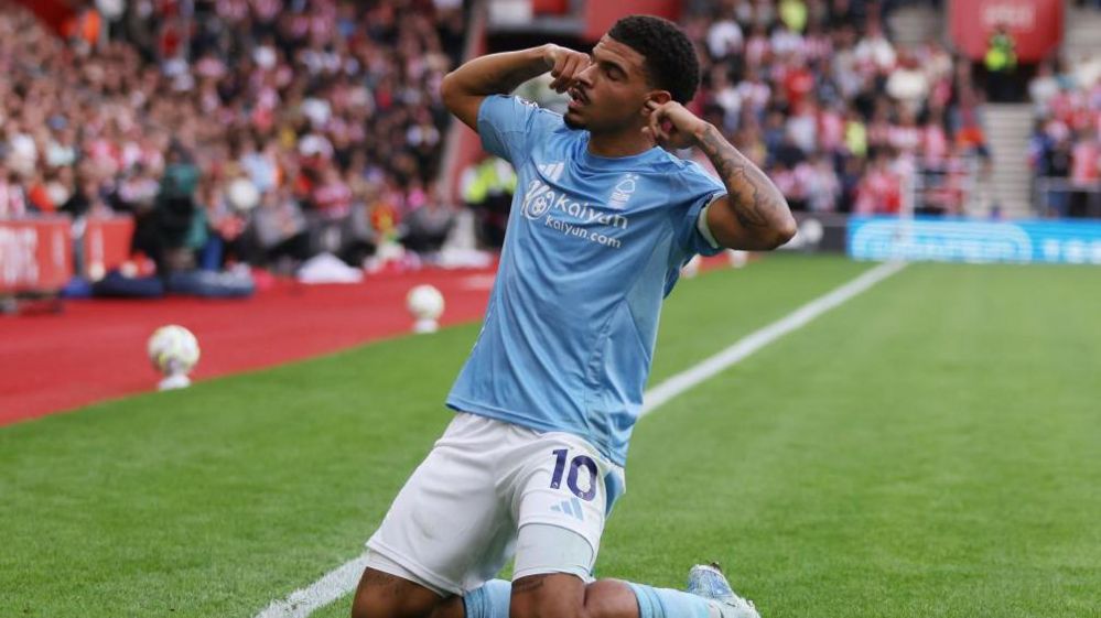 Morgan Gibbs-White on his knees with his fingers in his ears after scoring for Nottingham Forest