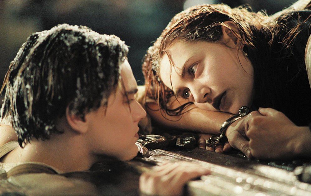 Titanic film characters Jack and Rose floating in the sea holding on to wooden door panel