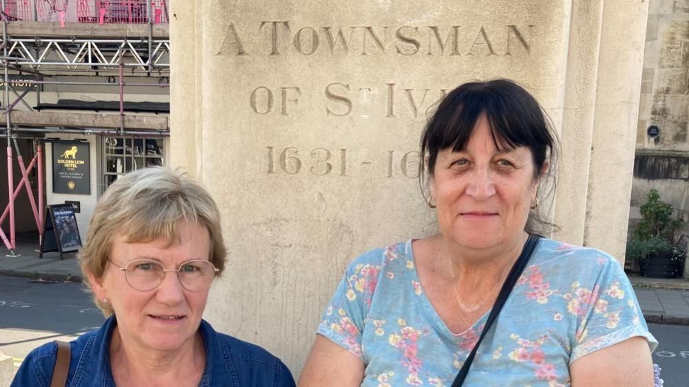 Ann Cook and Margaret Lloyd in front of plinth of Cromwell statue