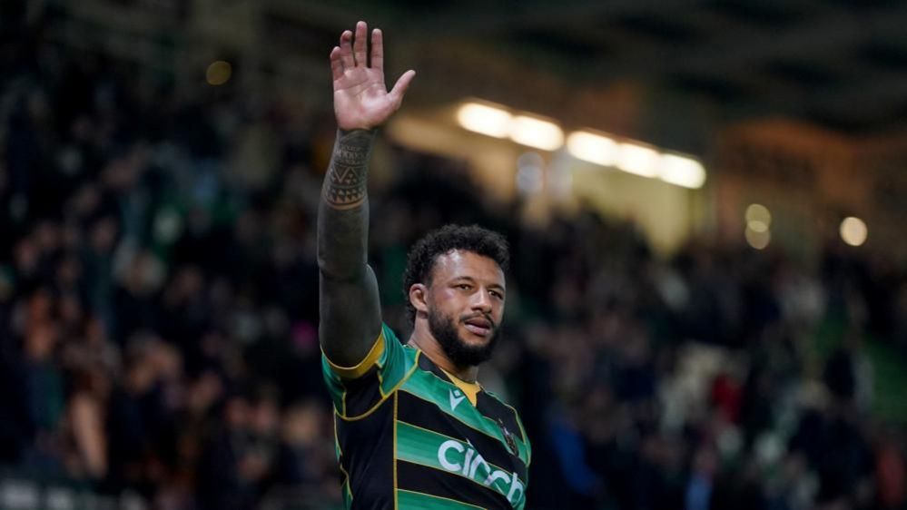 Courtney Lawes with dark hair and beard waving during a Saints game