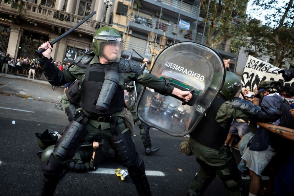 Demonstrators clash with law enforcement officers during a protest outside the National Congress in Buenos Aires, Argentina