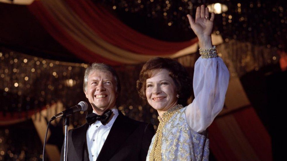 Former US President Jimmy Carter and First Lady Rosalynn Carter waving to inaugural ball guests on the evening of 20 January 1977.