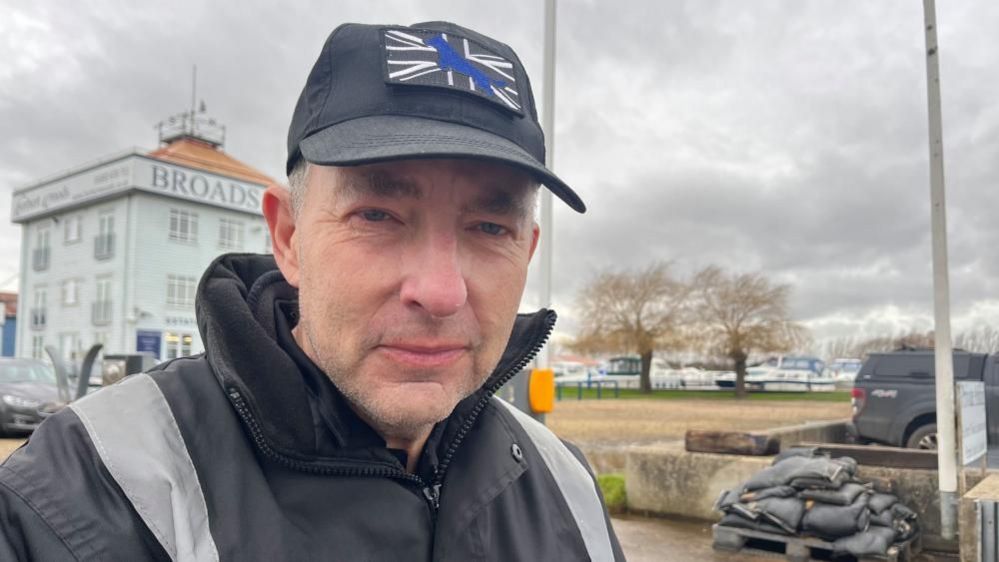 Paul Rice pictured by flood defences in Potter Heigham