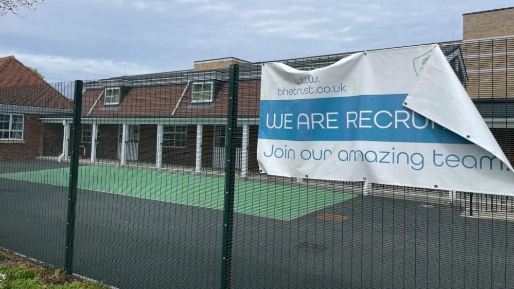Recruitment banner hanging from fence at Bure Park Specialist Academy