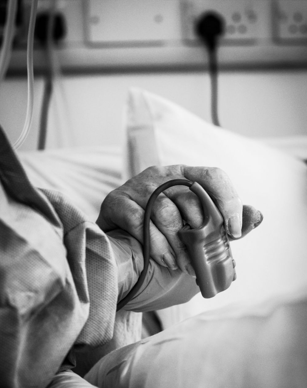 Intensive care unit staff holding a patents hand