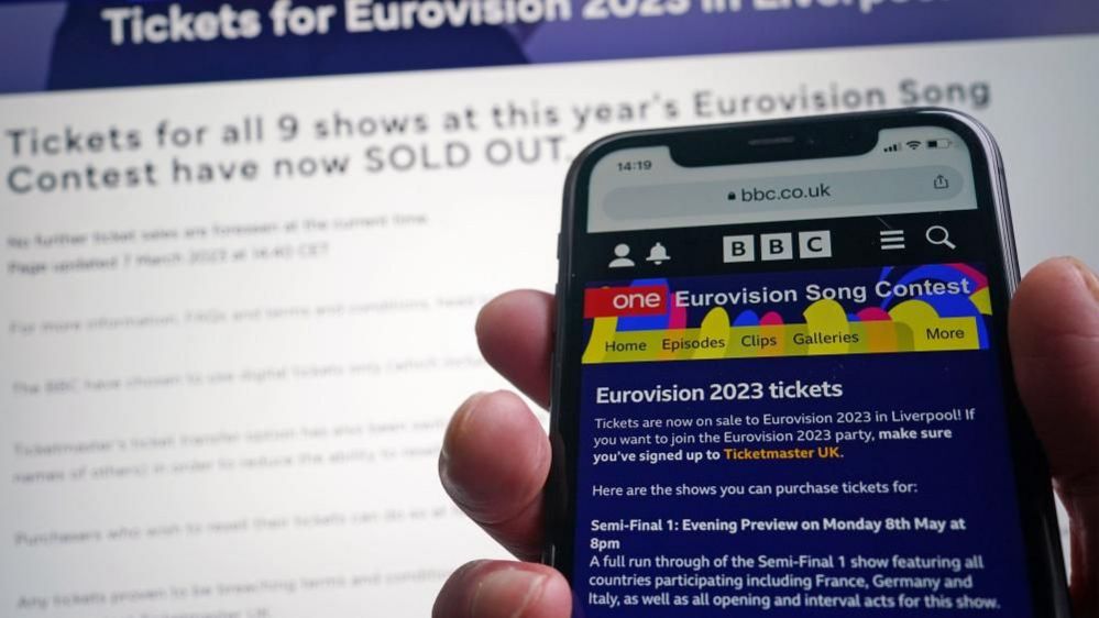 Hand hold mobile phone showing Eurovision page