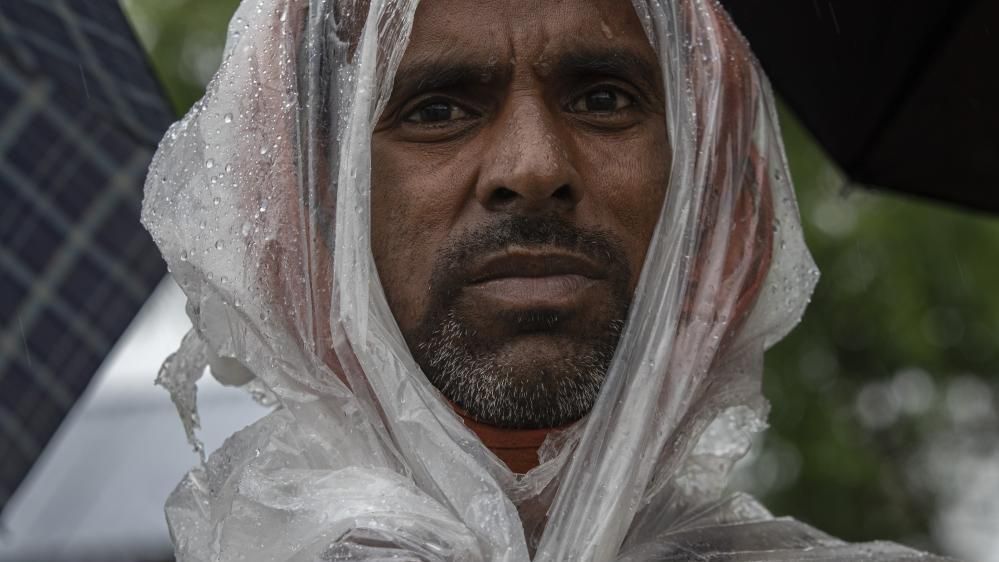 A Nepalese man takes shelter near the temple area after torrential rains in Kathmandu, Nepal, 6 July 2024. 