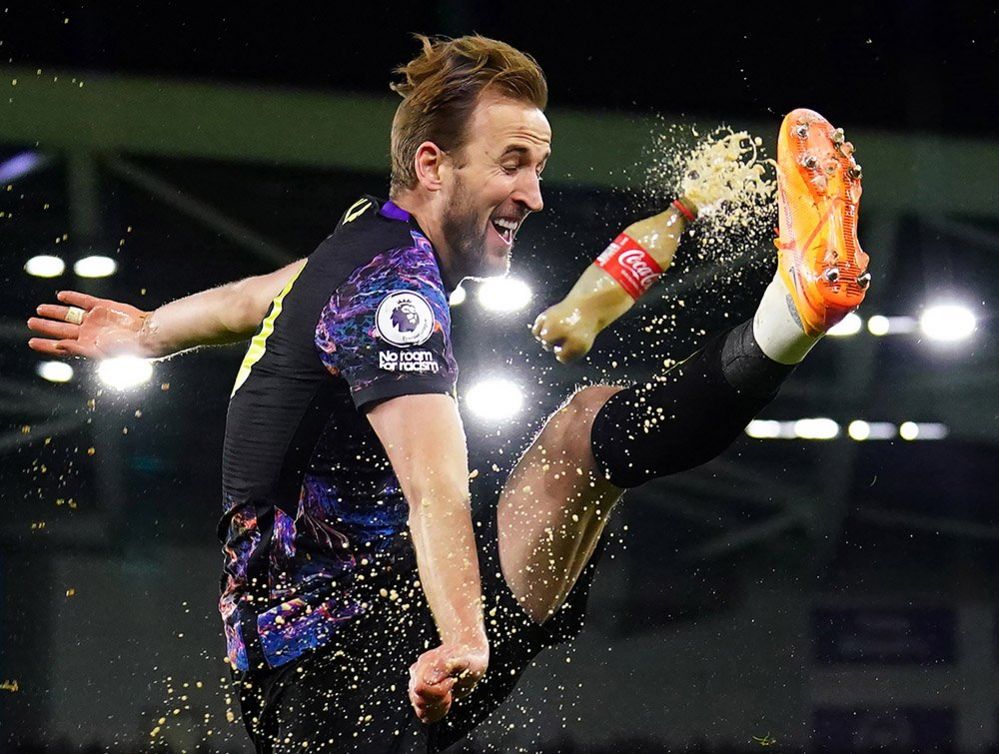 A bottle of cola is thrown as Tottenham Hotspur's Harry Kane celebrates scoring their side's second goal of the game during the Premier League match at the AMEX Stadium, Brighton, 16 March 2022