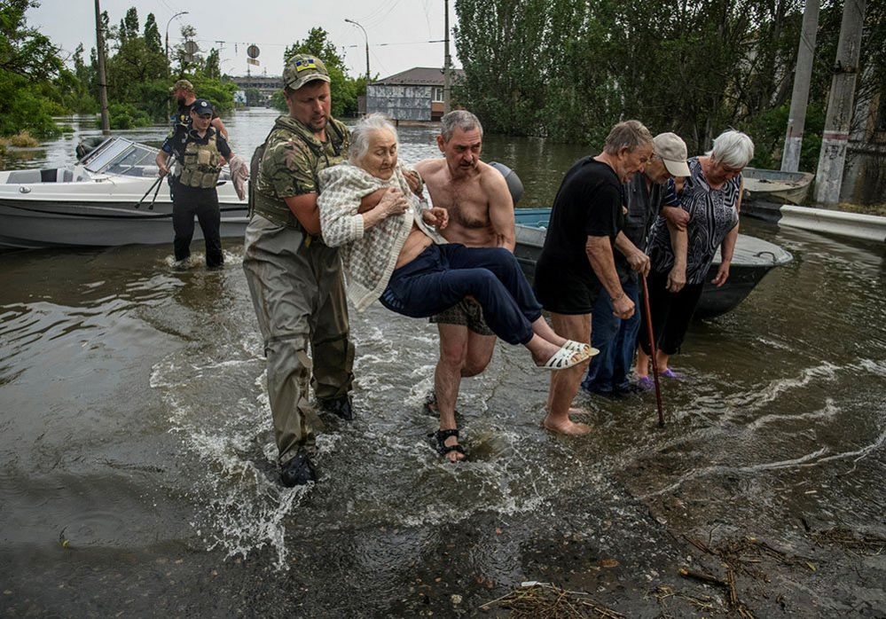 Rescuers evacuate local residents from a flooded area of Kherson, Ukraine