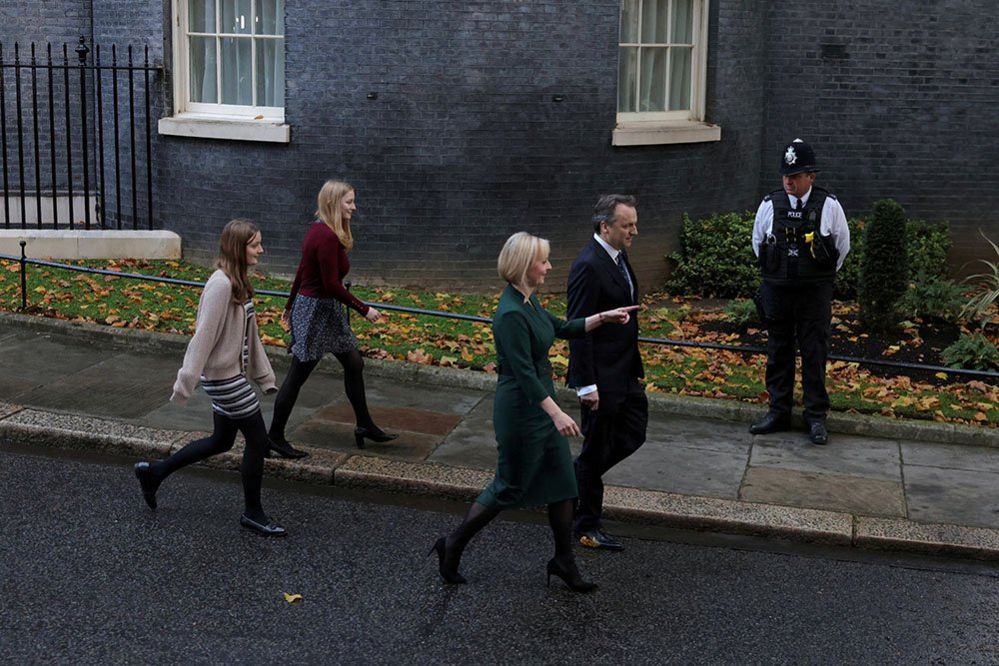 Liz Truss walks in Downing Street with her husband Hugh O'Leary and daughters Frances and Liberty on her last day in office