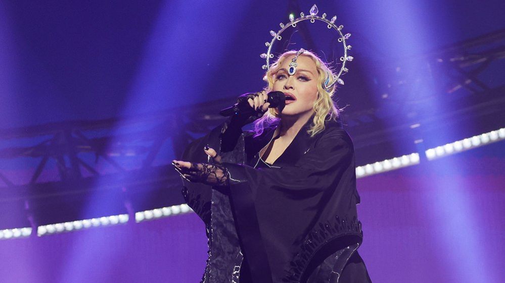 Madonna sings into a microphone while performing during the opening night of The Celebration Tour at The O2 Arena on October 14, 2023 in London, England