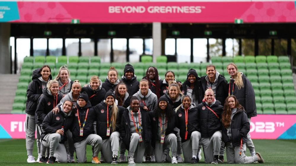 Canada players pose for a photograph inside the World Cup stadium