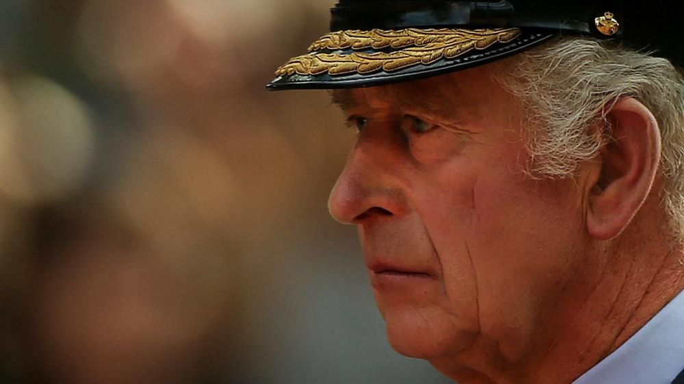 Prince Charles looking on to coffin