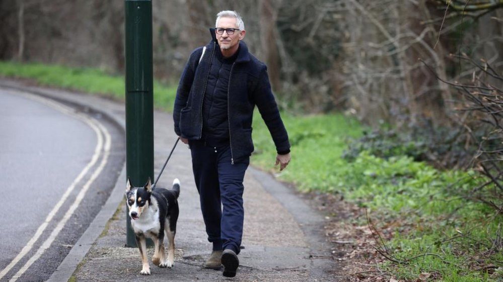 Gary Lineker walking with his dog