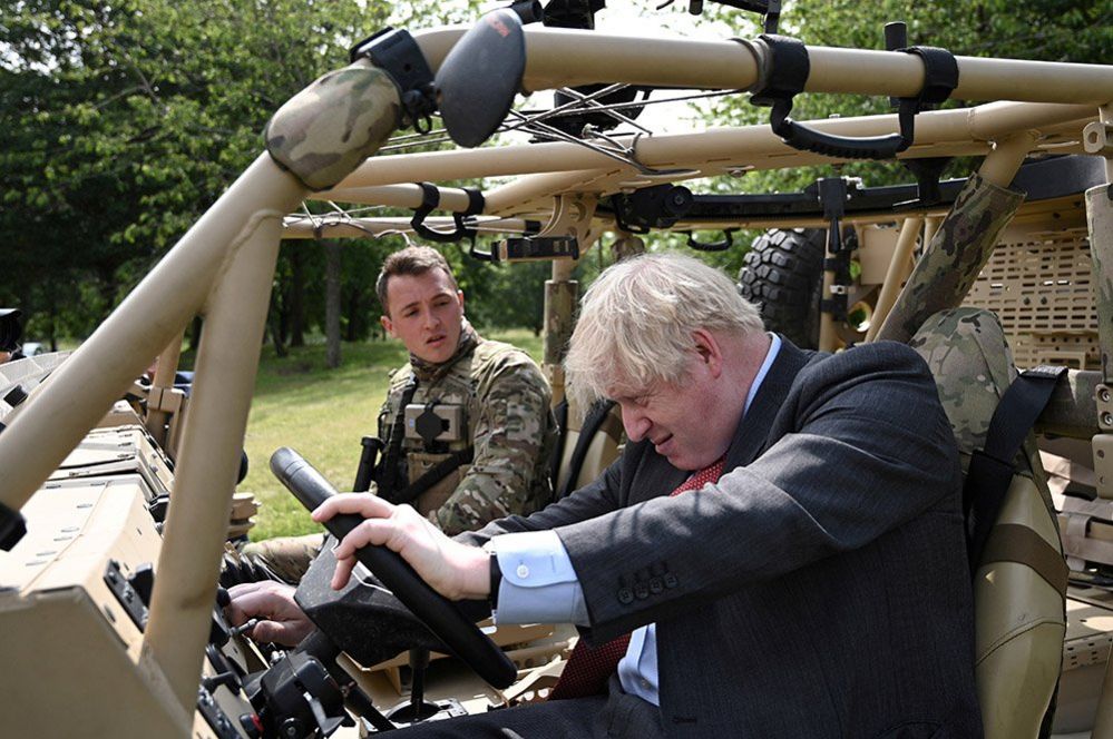 Boris Johnson poses in an armoured vehicle