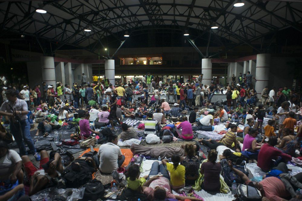 Migrants rest in the main square in Tapachula