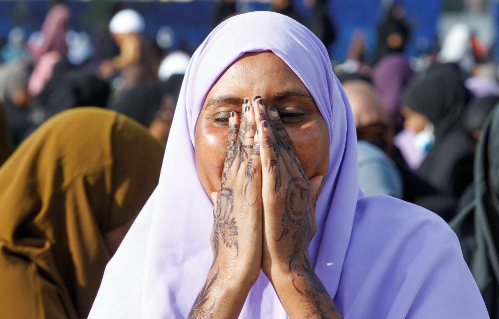 A Muslim woman attends Eid al-Fitr prayers