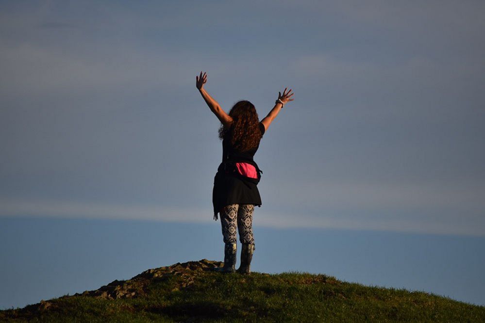 Woman at the top of a hill