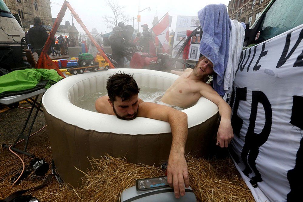 Jean-Philippe and Gabriel sit in a hot tub in Ottawa