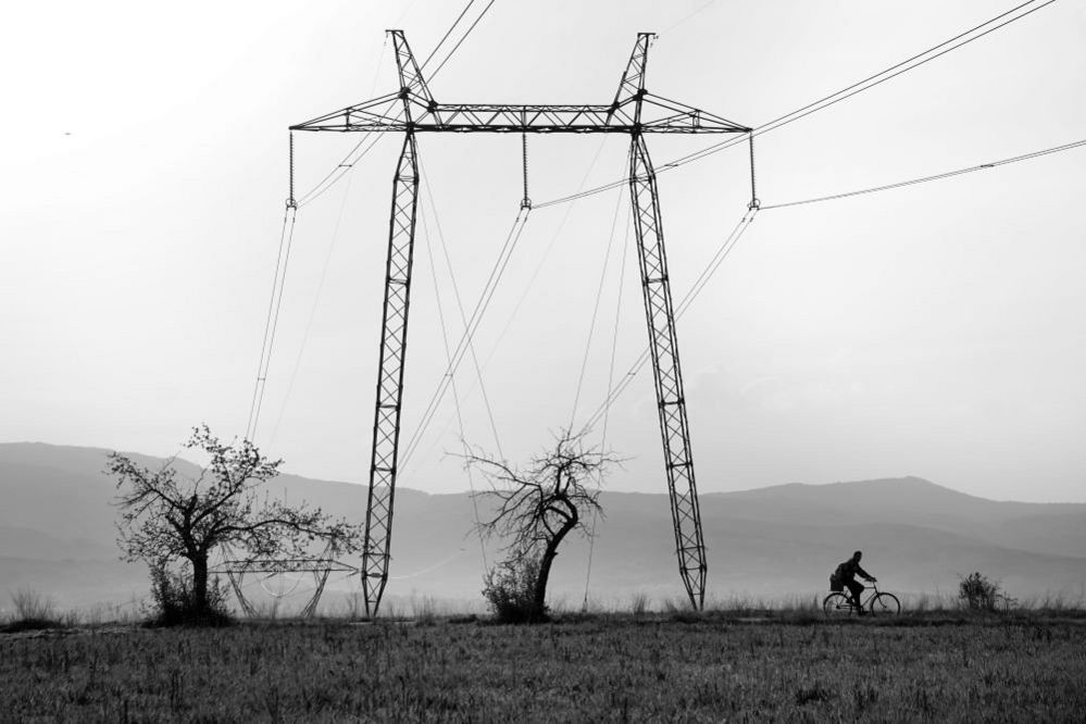 A cyclist passing pylons