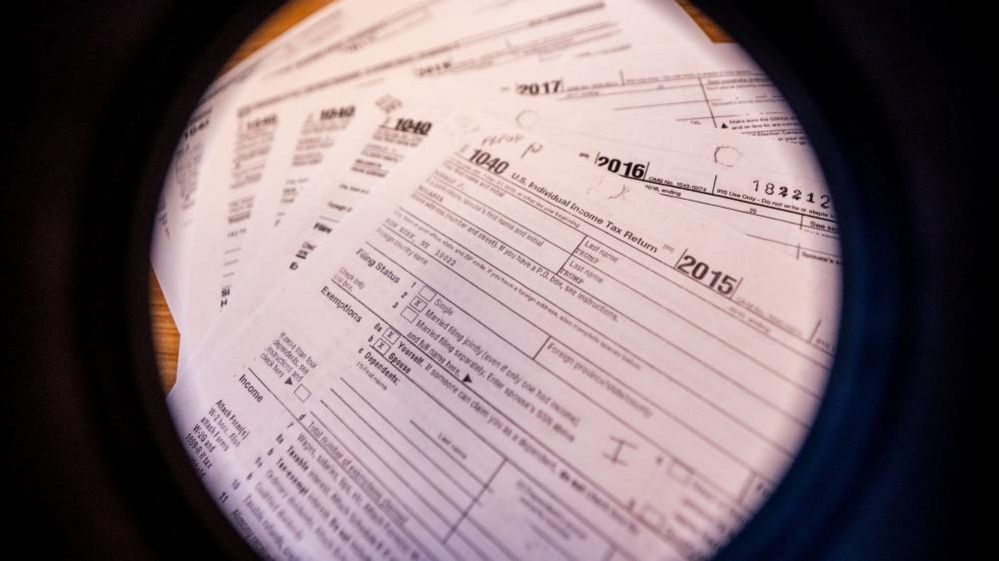 A tax form seen through a spyglass