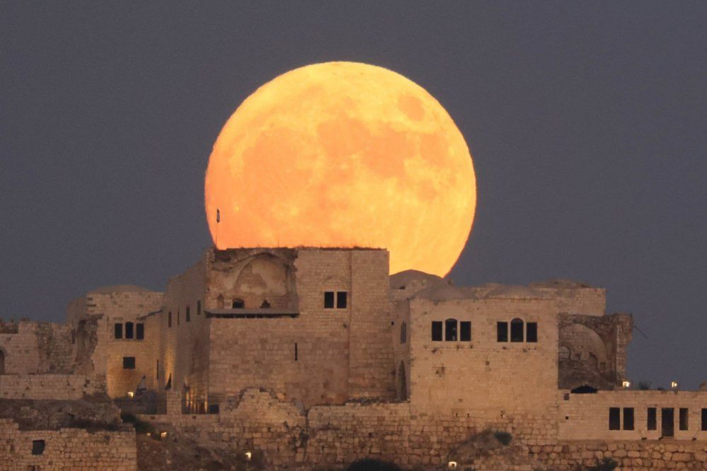 Super Blue Moon rises above ancient fortress in Migdal Tsedek National Park near Rosh Haayin, Israel, 30 August