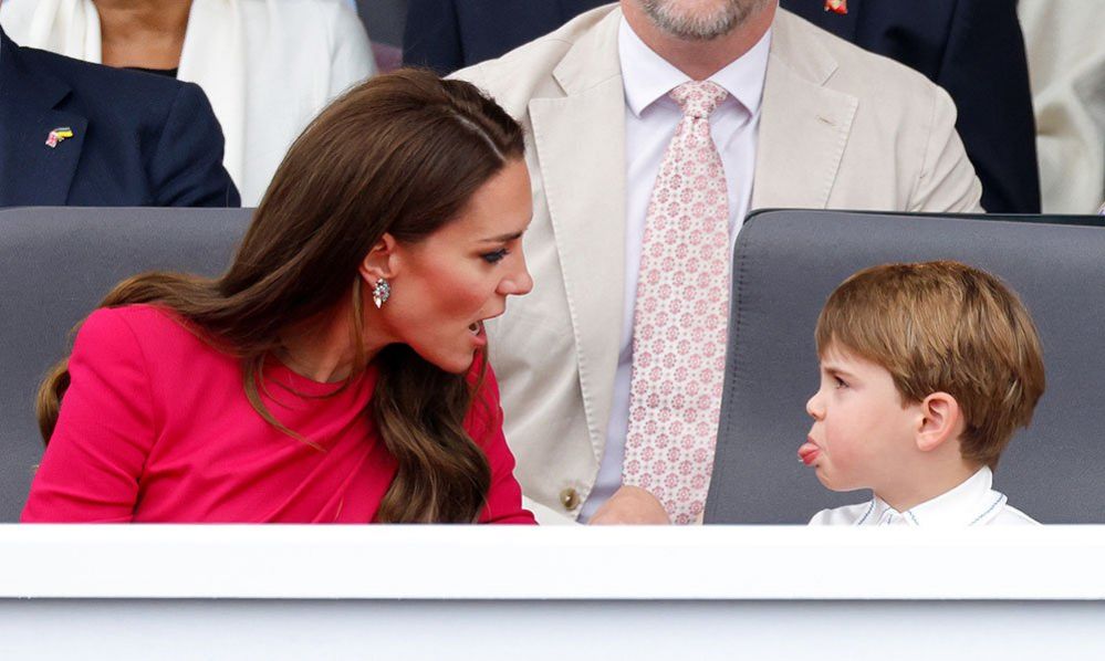 Prince Louis of Cambridge sticks his tongue out at his mother Catherine, Duchess of Cambridge, as they attend the Platinum Pageant on The Mall
