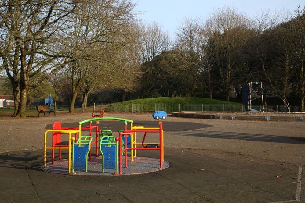 An empty children's play area on Llandaff Fields in Cardiff