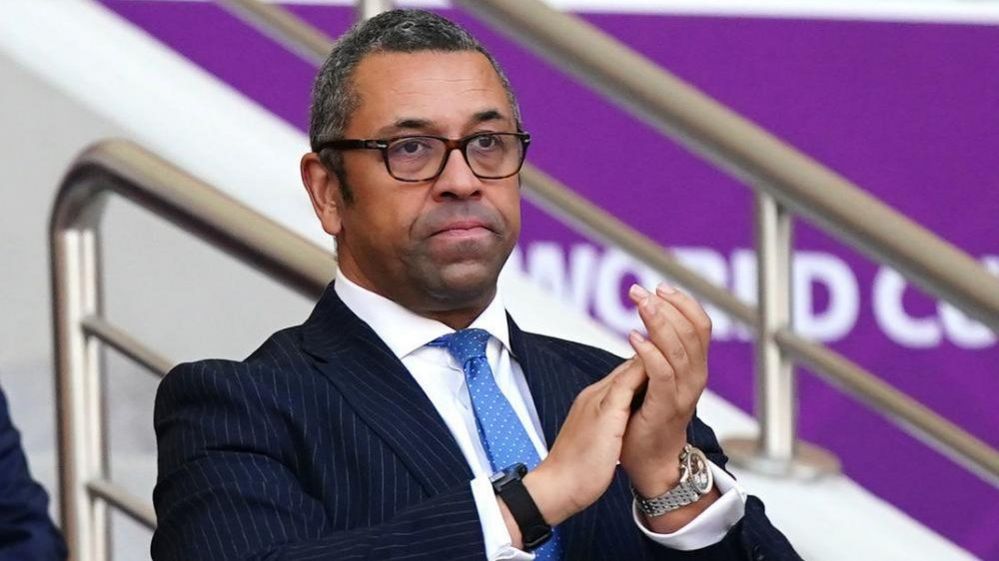British Foreign Secretary James Cleverly applauds while attending a game at the 2022 World Cup in Qatar