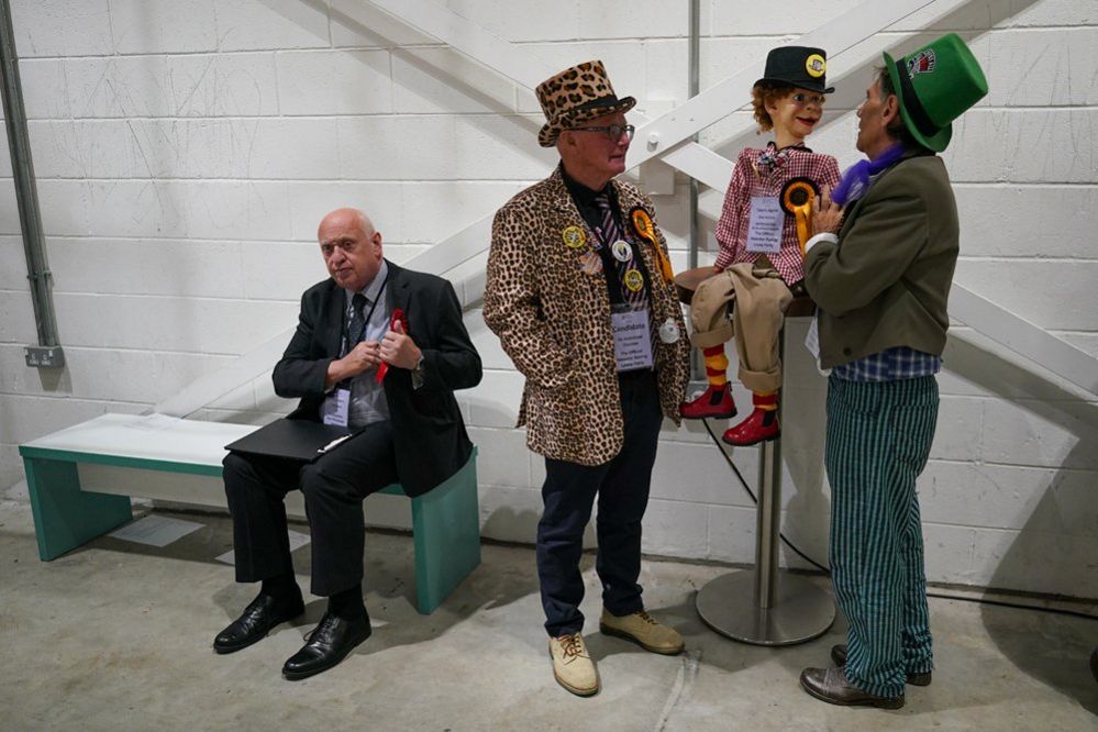Count agents from the Labour Party (L) and the Official Monster Raving Loony Party attend the count at Selby and Ainsty