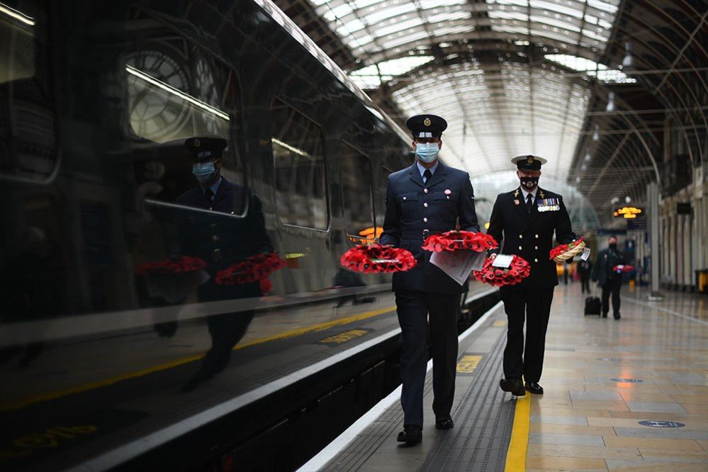Military personnel carry poppy wreaths at Paddington Station in London, for 'Poppies to Paddington'.