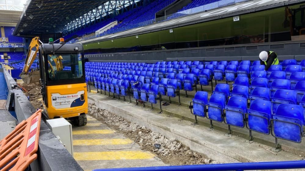 Workman and a machine in the stands at Portman Road